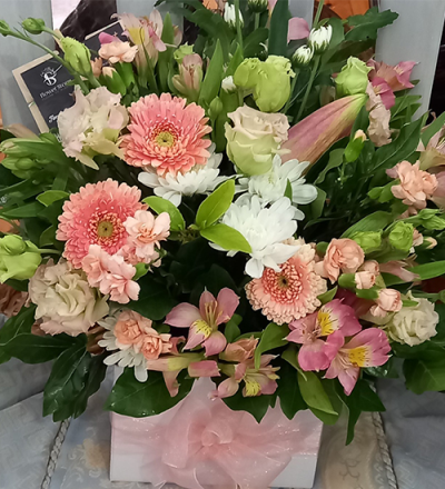 Peach Mix - A beautiful container arrangement, created using the fresh blooms of the day in all peach/pink with complementary foliage.
